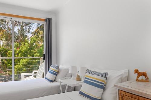 a living room with a white couch and a window at Halcyon Days in St Helens