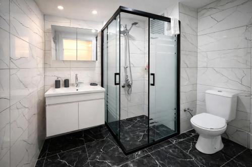 a bathroom with a shower and a toilet and a sink at Valentina Apart Hotel in Istanbul