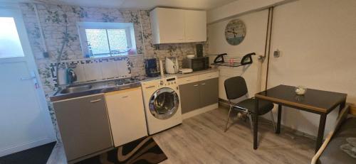 a kitchen with a sink and a washing machine at Small, cozy tiny apartment, complete in Lichtenau