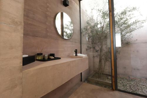 a bathroom with a sink and a mirror at Hacienda Lagunillas in Querétaro