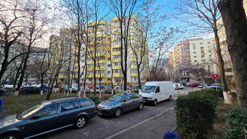 a group of cars parked on a street with buildings at AVS Concept Obor in Bucharest