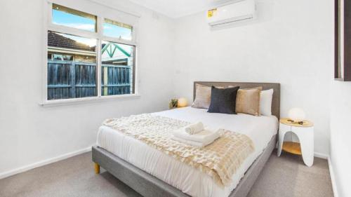 a bedroom with a large bed with a window at Sunnybank House with EV Charger in Cheltenham