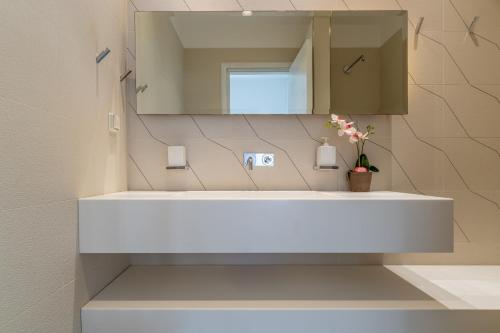 a bathroom with a white sink and a mirror at Lindos 4 me Villa in Lindos
