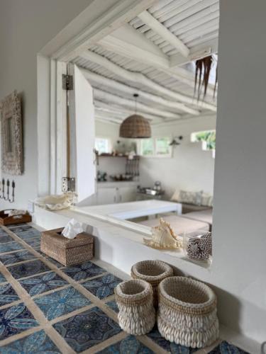 a bathroom with a tub and baskets on the floor at My Island Home Vanuatu in Eton