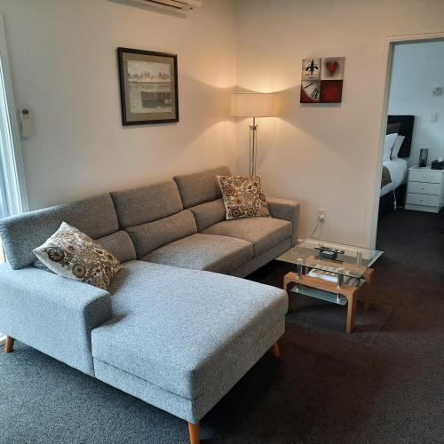 a living room with a couch and a coffee table at Villa One on Fitzherbert in Palmerston North