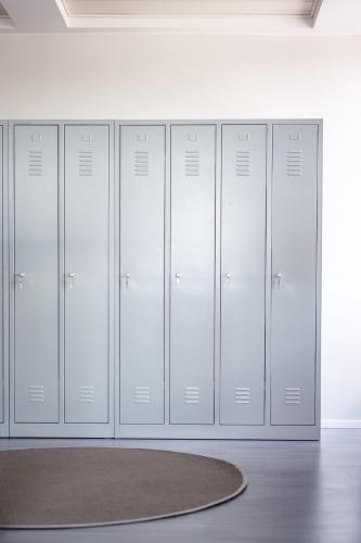 a row of lockers in a room with a rug at Hostel Café Koti in Rovaniemi