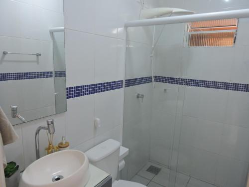 a bathroom with a toilet and a glass shower at Recanto da Natureza in Imbituba