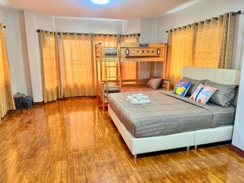 a bedroom with a bed and a bunk bed at Mata Villa Krabi Town in Krabi