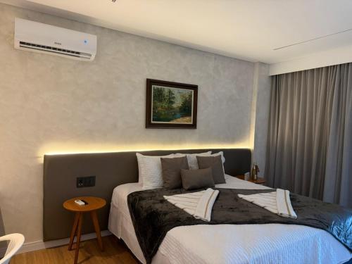 a bedroom with a large bed with a night light at Amélia Pousada de Charme in Porto De Galinhas