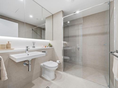 a bathroom with a toilet and a sink and a shower at The Sky Perch in Sydney
