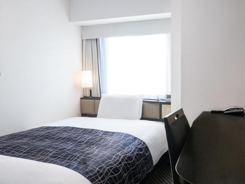 En eller flere senge i et værelse på APA Hotel Keisei Ueno Ekimae