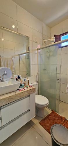 a bathroom with a toilet and a sink and a shower at Casa Ponta de Campina in Cabedelo