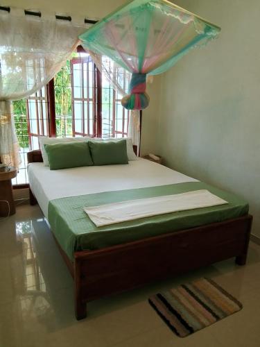a bed with a canopy in a room at SiSi Place in Dickwella