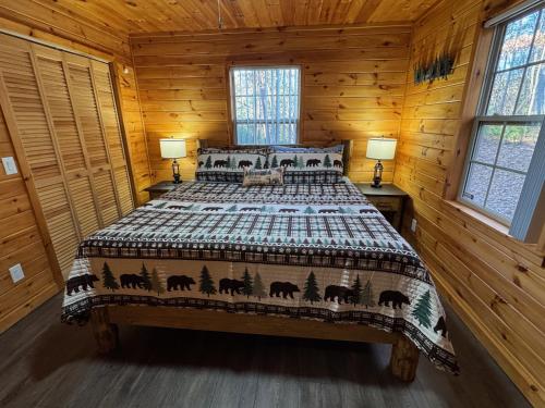 a bedroom with a bed in a log cabin at Hillside Hideaway Cabin in Blairsville