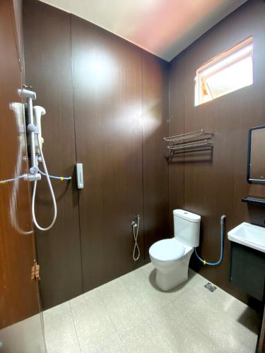 a bathroom with a toilet and a shower at Samudera Hotel in Kampung Kuala Besut