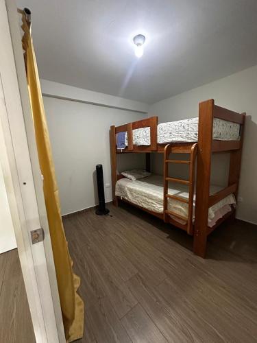 a room with two bunk beds and a speaker at Mn Depa en San Bartolo in San Bartolo