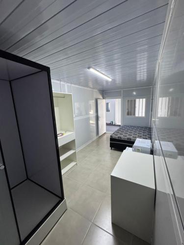 En eller flere senge i et værelse på Residencial Manhattan