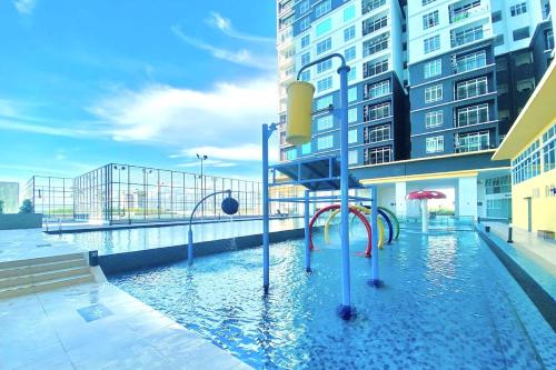 a pool with a water slide in the middle of a building at NOVO 8 Residence Melaka in Malacca