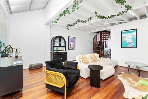 a living room with a couch and a table at 5 North Freo 2BR Supercool Pad & Parking in North Fremantle