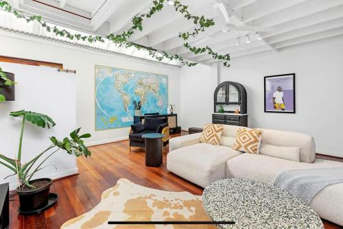 a living room with a couch and a table at 5 North Freo 2BR Supercool Pad & Parking in North Fremantle