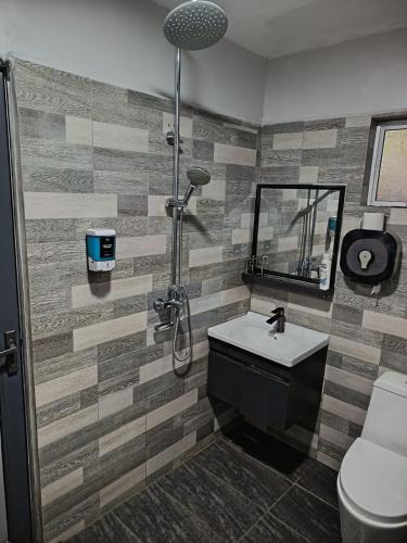 a bathroom with a shower and a sink and a toilet at Macchiato Homestay - Musslim Homestay in Klang