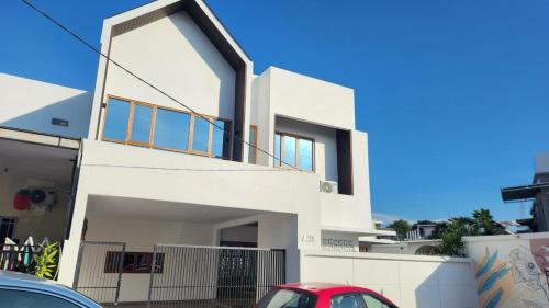 a white house with a red car parked in front of it at Danka Luxury Villa in Batam Center