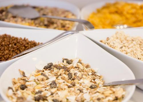 a bowl of granola on a table with other foods at Go Hotel Ansgar in Copenhagen
