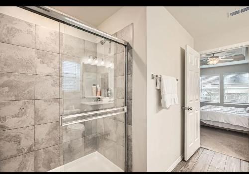 a bathroom with a shower with a glass door at Modern Retreat with Private Office in Heath