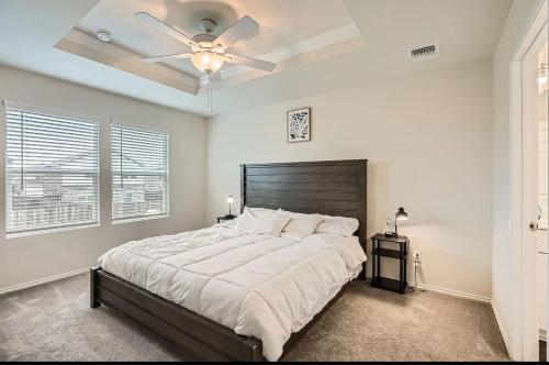 a bedroom with a large bed with a ceiling fan at Modern Retreat with Private Office in Heath