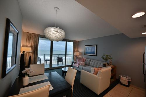 a living room with a couch and a table at Stylish 1BR Oceanfront Stay in the Heart of Myrtle Beach 3rd Fl of OO Resort in Myrtle Beach