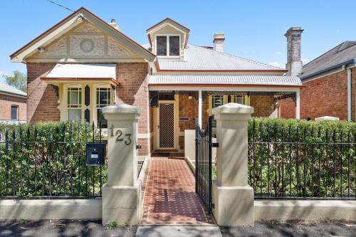 a house with a gate in front of it at Kyogle123 Central location in Orange