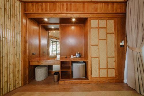 a bathroom with a sink and a wooden wall at Aonang Fiore Resort in Ao Nang Beach