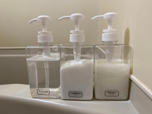 three bottles of soap sitting on top of a sink at #29 -フェイズ立川- Entire Unit in Tachikawa