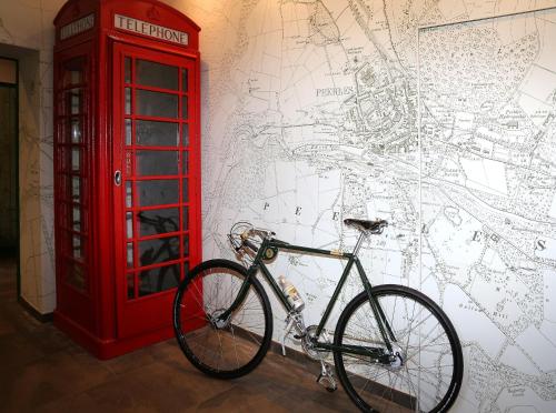 a bike parked next to a red phone booth at The Park in Peebles