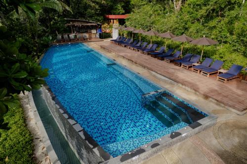 an overhead view of a swimming pool with chairs and umbrellas at Aonang Fiore Resort in Ao Nang Beach