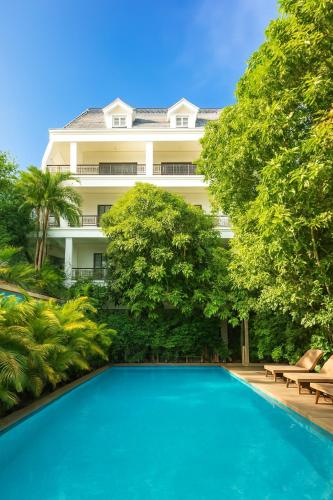 a swimming pool in front of a building at Golden Citadel Hotel Siem Reap in Siem Reap