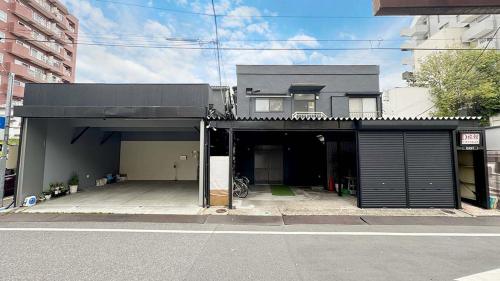 a house with a parking lot with a garage at D旅館　Dryokan in Tokyo