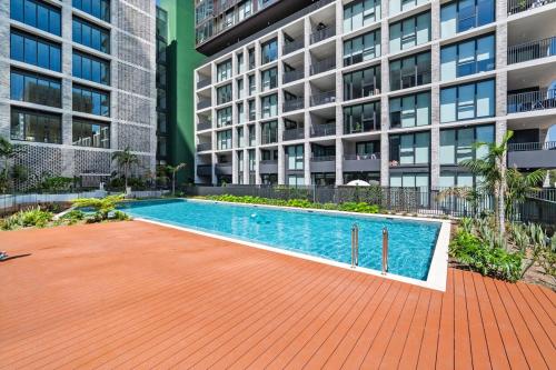 a swimming pool in front of a building at SOP 18 Stylish and Cosy 2 Bedroom Apt in Sydney