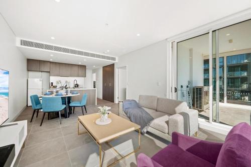 a living room with a couch and a table at SOP 18 Stylish and Cosy 2 Bedroom Apt in Sydney
