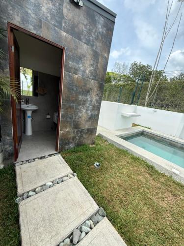 a bathroom with a sink and a swimming pool at Casa kai in Agujas