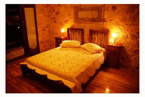 a bedroom with a bed with two night stands and two lamps at Villa Danae in Meganisi