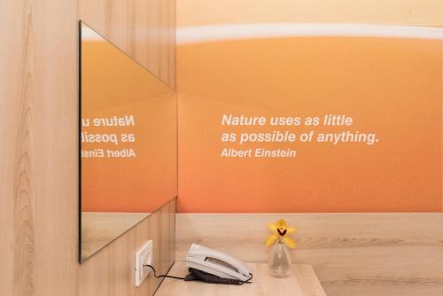 a phone sitting on a desk with a mirror at Residence Umag Plava Laguna in Umag