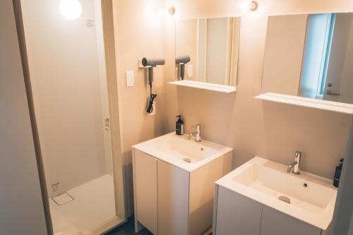 a bathroom with two sinks and a shower at Bed and Vegetable Kahoku 