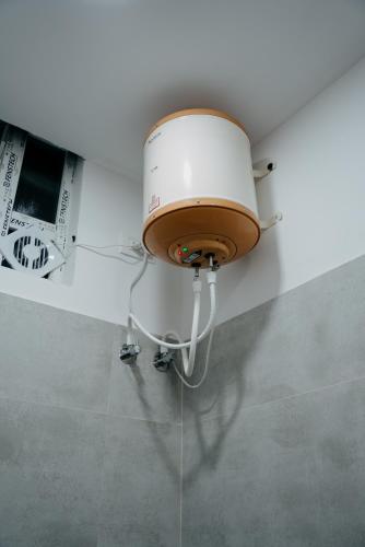 a light on the corner of a room with a ceiling at Fenna Resort And Spa, coorg in Kushālnagar