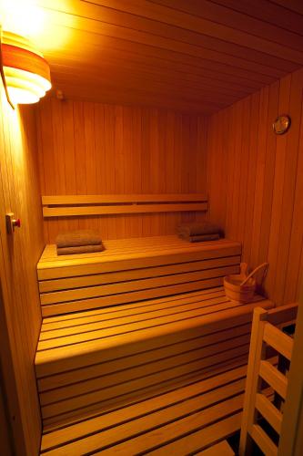 a sauna with a bench in a wooden room at Best Western Plus The Hub Hotel in Milan