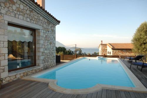 a swimming pool in the backyard of a house at Villa Danae in Meganisi