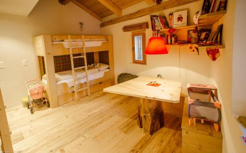 a room with a desk and a bunk bed at Chesa Chamuera in La Punt-Chamues-ch