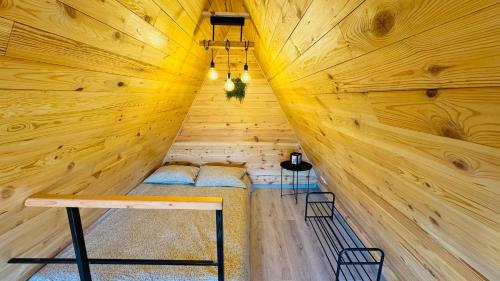 a wooden room with two beds in a sauna at Secluded A-Frame Cabin with Private Hot Tub & Views - IezerVenture in Şelari