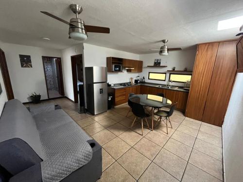 a living room and kitchen with a couch and a table at CASA NORMA in Guadalajara