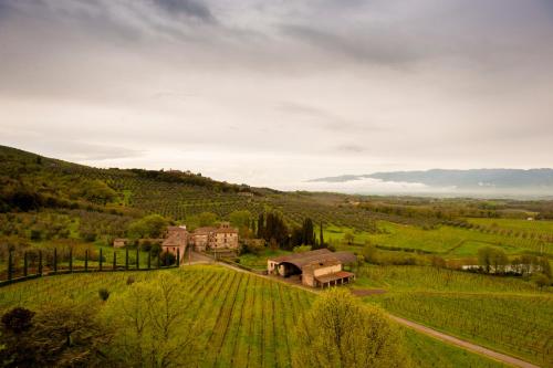 an aerial view of a house in a green field at Tenuta Lupinari in Bucine